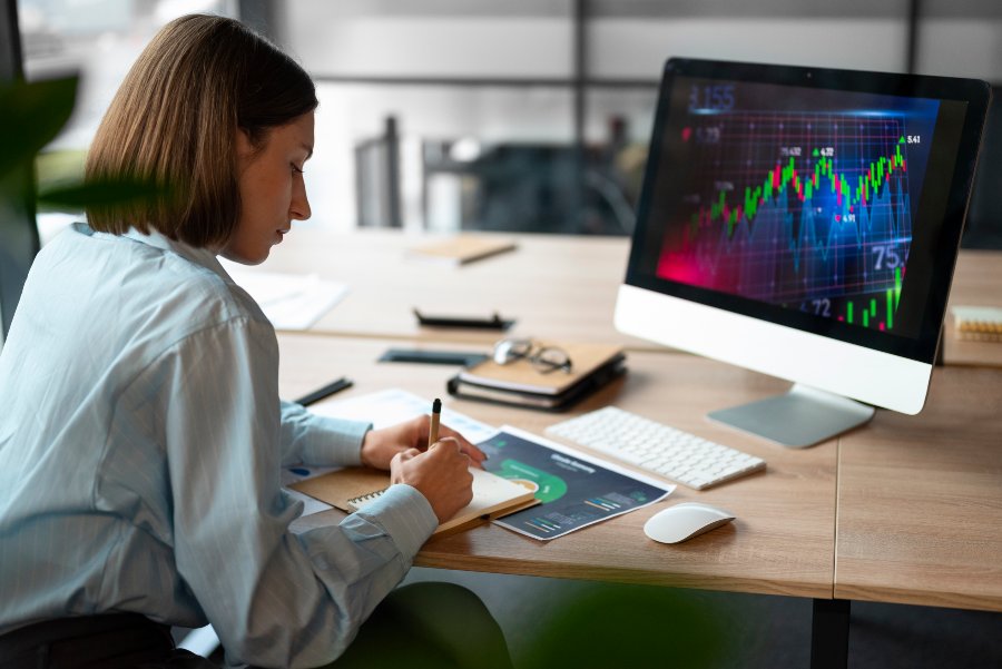 person office analyzing checking finance graphs