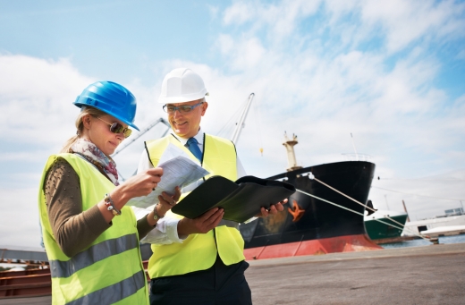 Two owners reviewing the documentation for the registration of their ship