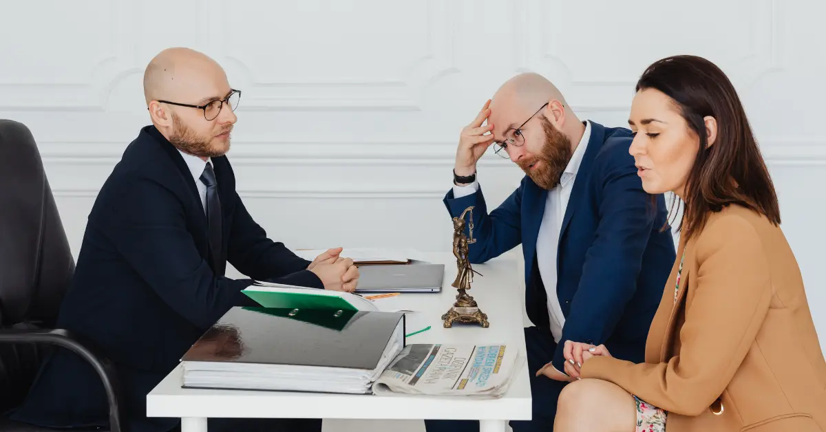 Lawyer and couple consulting about divorce in an office